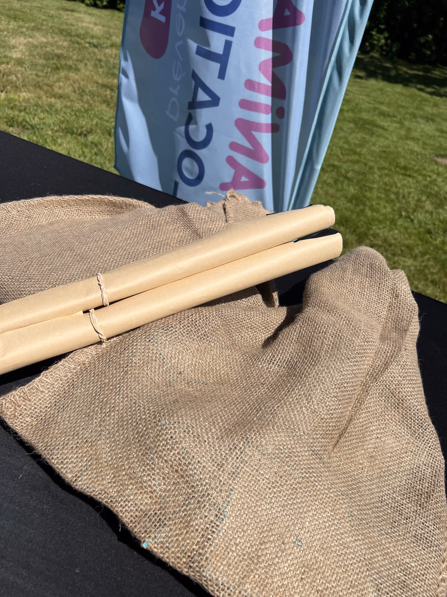 deux rouleaux en papier kraft positionné sur les sacs en jute comportant les Tangrams